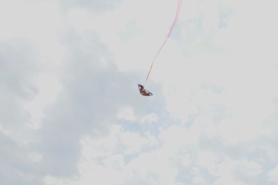 Low angle view of kite flying against sky