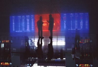 Woman standing in illuminated city at night