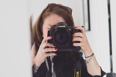 Portrait of woman photographing