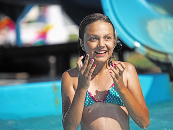 Portrait of a smiling young woman in swimming pool