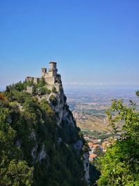 Buildings in city against clear sky