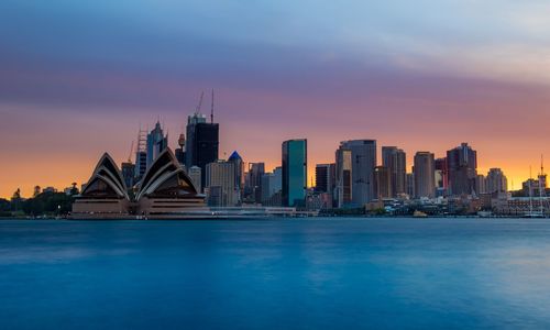 View of buildings in city at sunset