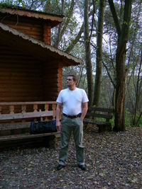 Portrait of young man standing in forest