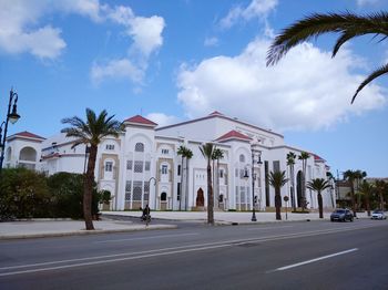 Road by building against sky