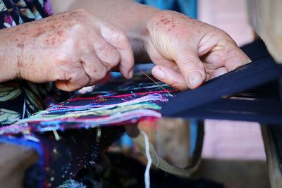 Close-up of hands weaving