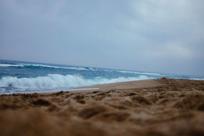 Scenic view of beach against blue sky