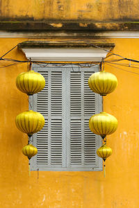 Yellow lanterns hanging at both sites of closed window