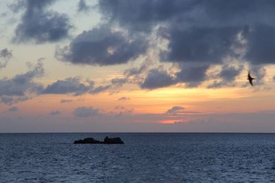 Scenic view of dramatic sky over sea during sunset