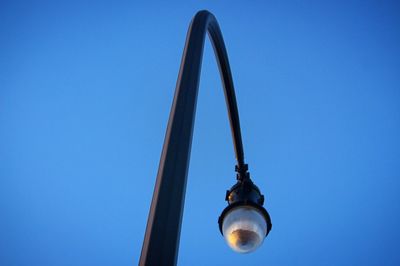 Low angle view of metal against blue sky