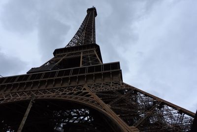 Low angle view of tower against cloudy sky