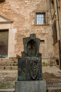 Old sculpture against building