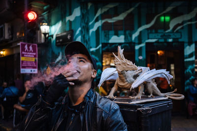 Portrait of man in city at night