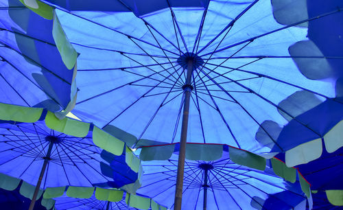 Low angle view of umbrellas hanging against ceiling