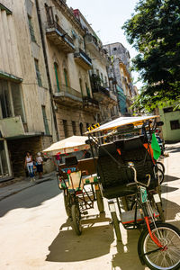 People on street against buildings in city