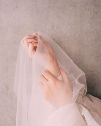 Close-up of woman holding veil