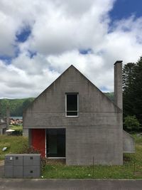 Buildings on field against sky