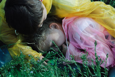 Close-up of siblings lying on yellow flowers