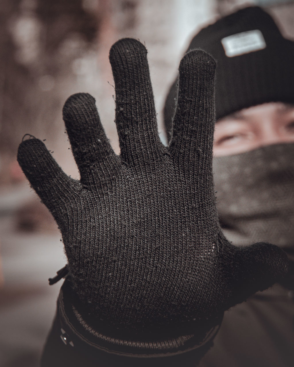 CLOSE-UP OF HUMAN HAND ON SNOW COVERED