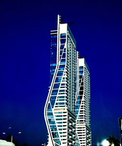 Low angle view of modern building against clear blue sky