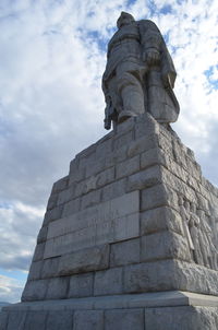 Low angle view of statue against cloudy sky