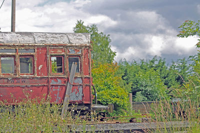 Abandoned built structure on landscape against sky