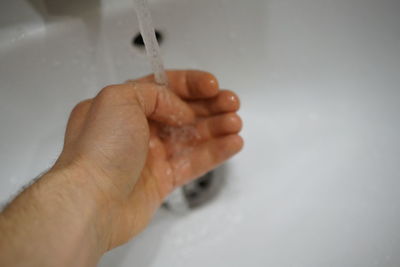 Close-up of person hand holding water