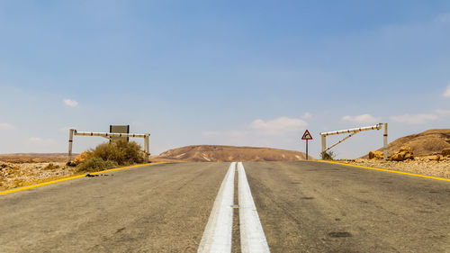 Surface level view of country road against sky