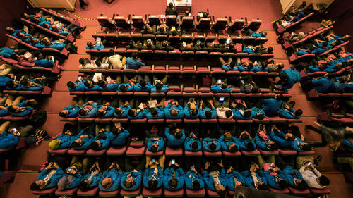 High angle view of people sitting in auditorium