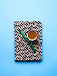 High angle view of coffee on table against blue background