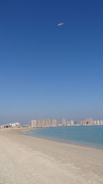 View of cityscape against clear blue sky