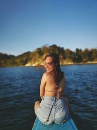 Portrait of woman sitting in boat on sea