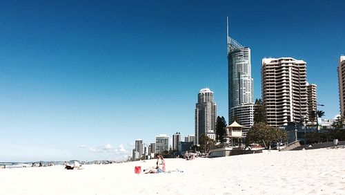 Modern buildings against clear blue sky