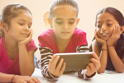 Girls looking at digital tablet