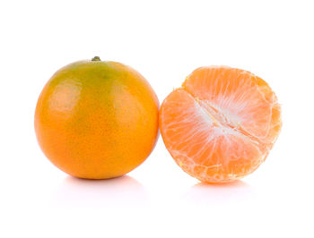 Close-up of orange fruit against white background