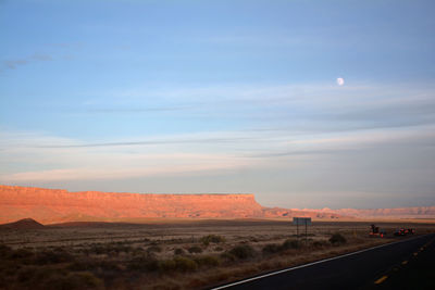 Road by landscape against sky