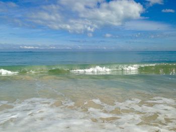 Scenic view of sea against cloudy sky