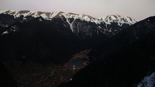 Scenic view of snowcapped mountains against sky at night