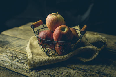 Close-up of apples in basket on table