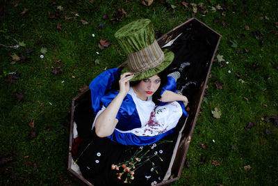 Portrait of young woman sitting on grassy field