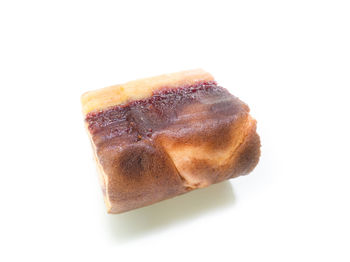 Close-up of bread over white background