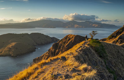 Scenic view of sea and mountains against sky