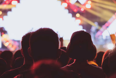 Rear view of people enjoying at music concert