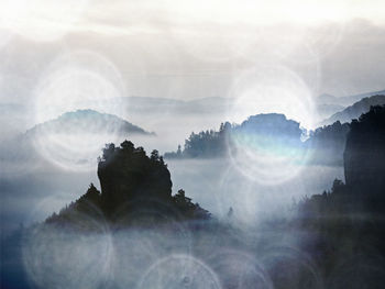 Digital composite image of mountain against sky