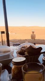 Breakfast on table against clear sky in desert oman