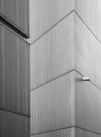 Low angle view of railing against white wall
