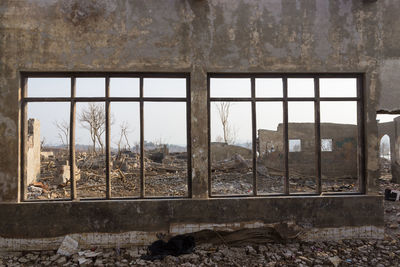 Abandoned building seen through broken window