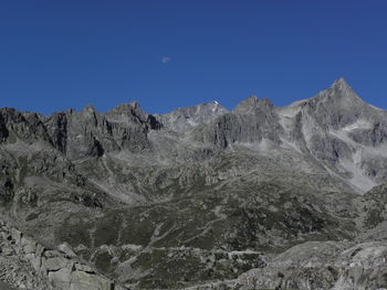 Scenic view of mountains against clear blue sky