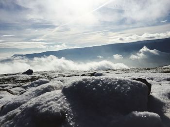 Surface level of frozen rocks against sky