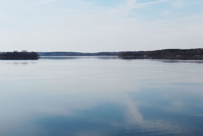 Scenic view of lake against sky during winter