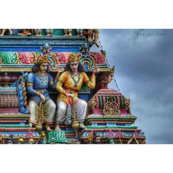 Low angle view of statues on building against sky